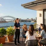 airbnb management sydney with property manager welcoming guests at stylish Airbnb overlooking Sydney Harbour