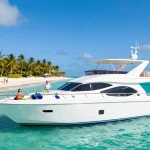 Luxury yacht rental Punta Cana with guests enjoying the sun on a beautiful beach day.